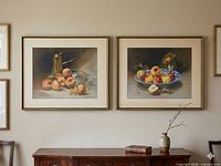 Both framed still life prints hanging side by side