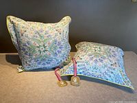 Front view of both cushions showing pattern, shape, piping