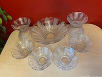 entire set showing large bowl center with eight small bowls around