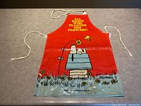 Full view of vinyl apron front showing design, ties, and graphics