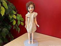 Full front view of doll on stand wearing jumper