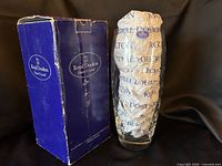 Vase wrapped in Royal Doulton tissue beside original blue box
