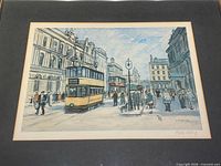 Full view of print under mat showing street scene and trams