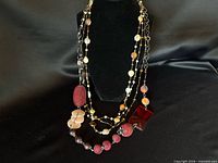 Both necklaces displayed on bust to show layering and bead details