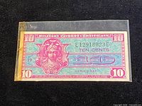 Front view of 10¢ MPC Series 521 inside sleeve showing full design and serial number