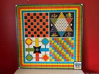 Full view of board showing chess/checkers, Chinese checkers, Parcheesi, Snakes & Ladders layouts