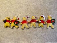 Group shot of all six flocked Winnie the Pooh ornaments