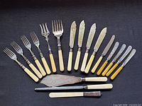 Entire 18-piece flatware grouping laid out on dark background