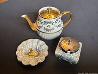 Teapot, plate and sugar bowl grouped