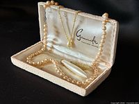All three faux pearl pieces displayed in open jewelry case