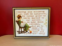 Front view of framed needlepoint art displaying imagery and poem