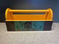 Full view of caddy front with cottage scene