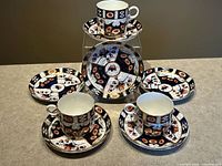 Complete set of three teacups and six saucers displayed