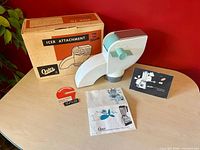 Attachment, box, manual, tag displayed on table