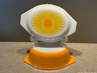 casserole base upside-down supporting lid showing full daisy design