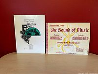 Front covers of both songbooks upright on table