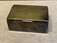 Angled view of closed box showing lid texture and patina