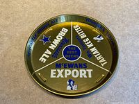 Top view of gold metal tray displaying full graphic layout and hand grips