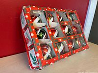 Closed box showing 12 ornaments through plastic windows