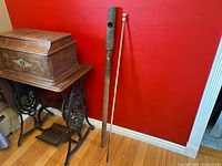 Full view of pump body and plunger rod leaning against wall