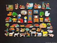 Full layout of all 45 wooden puzzle pieces showing variety of themes