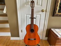 Full frontal view of Yamaha G-50A classical guitar on stand