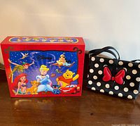 Handbag and storage box side by side on tabletop, full view of graphics and bag front