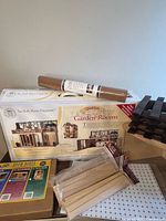 Overall lot showing Lake View Garden Rooms kit, cork roll, wood beams