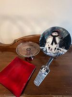Overview of snowman plate on stand, matching server, red glass pedestal stand, red glass platter