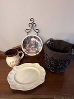 Group shot of all five items: basket, plate on stand, pitcher, platter