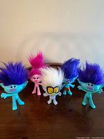 All five Trolls figures front view on tabletop