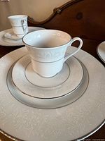 Stacked place setting showing dinner plate, saucer and teacup detail