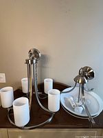 Both fixtures on dresser: chandelier, ceiling light, hardware, bulbs