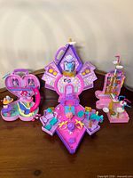 Overview of three My Little Pony mini fold-out playsets with figures shown open on tabletop