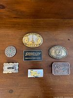 All seven buckles displayed on surface