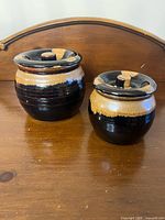 Front view of both crocks showing overall form and glaze