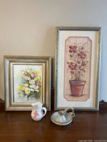 Group shot showing both framed prints, pitcher, and candle holder