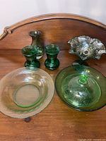 All seven green glassware pieces grouped together on table
