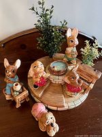 Overview of five Pendelfin figurines arranged on tiered stand