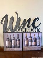 Overall lot showing metal sign on top of two plaques