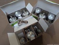 Open boxes and loose PAR20 halogen bulbs showing quantity and condition