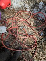 Coiled red-orange Mastercraft air hose showing length and quick-connect fitting