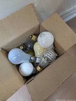 Box of mixed A19 and spiral CCFL bulbs