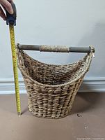 Front view showing full basket shape and tape measure indicating roughly 16-inch height