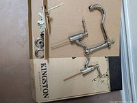 All faucet components and hardware on top of Kingston box