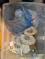 Bin containing Bunnykins china pieces and lamp wrapped in blue plastic