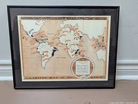 Front view of framed coffee map print in black metal frame with mat