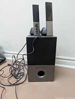 Subwoofer with two satellite speakers and cables
