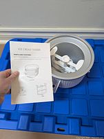 Freeze bowl with dasher and manual visible