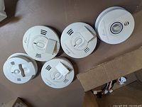 Top view of five Kidde detectors showing fronts